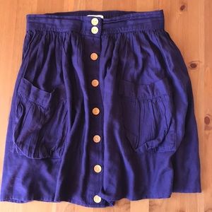 Purple knee length skirt, buttons, double pockets.